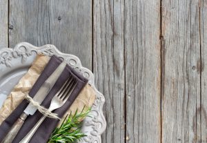 Vintage Table setting with napkin and plate on old wooden table